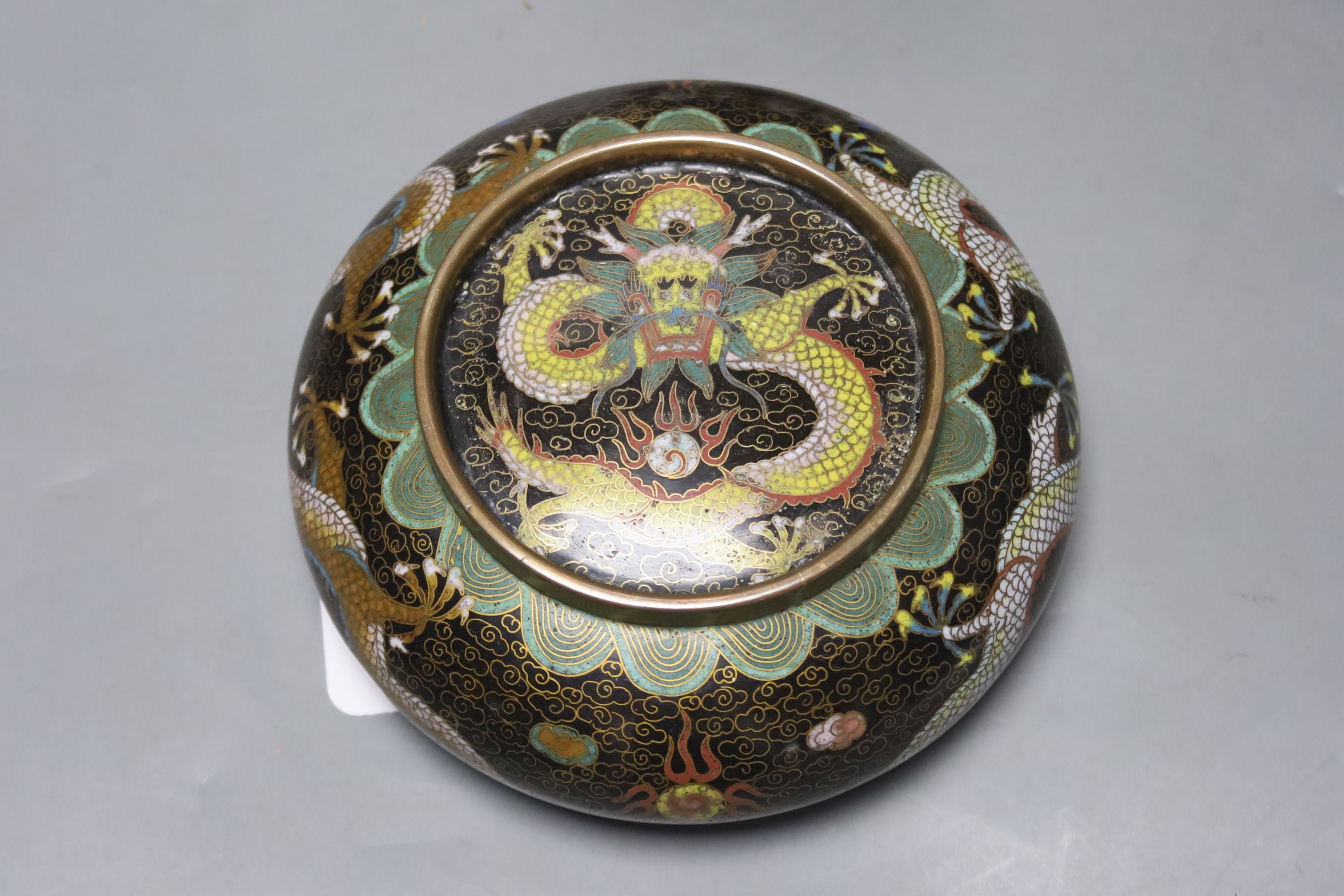 A pair of Chinese cloisonne enamel small 'dragon' bowls, wood stands